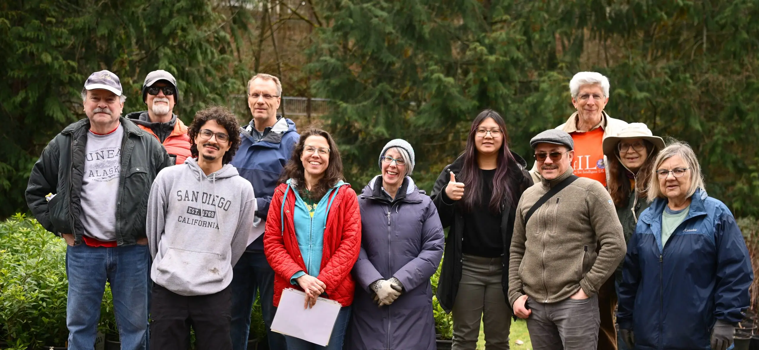 The 300Trees team and volunteers standing together outdoors at a tree giveaway event